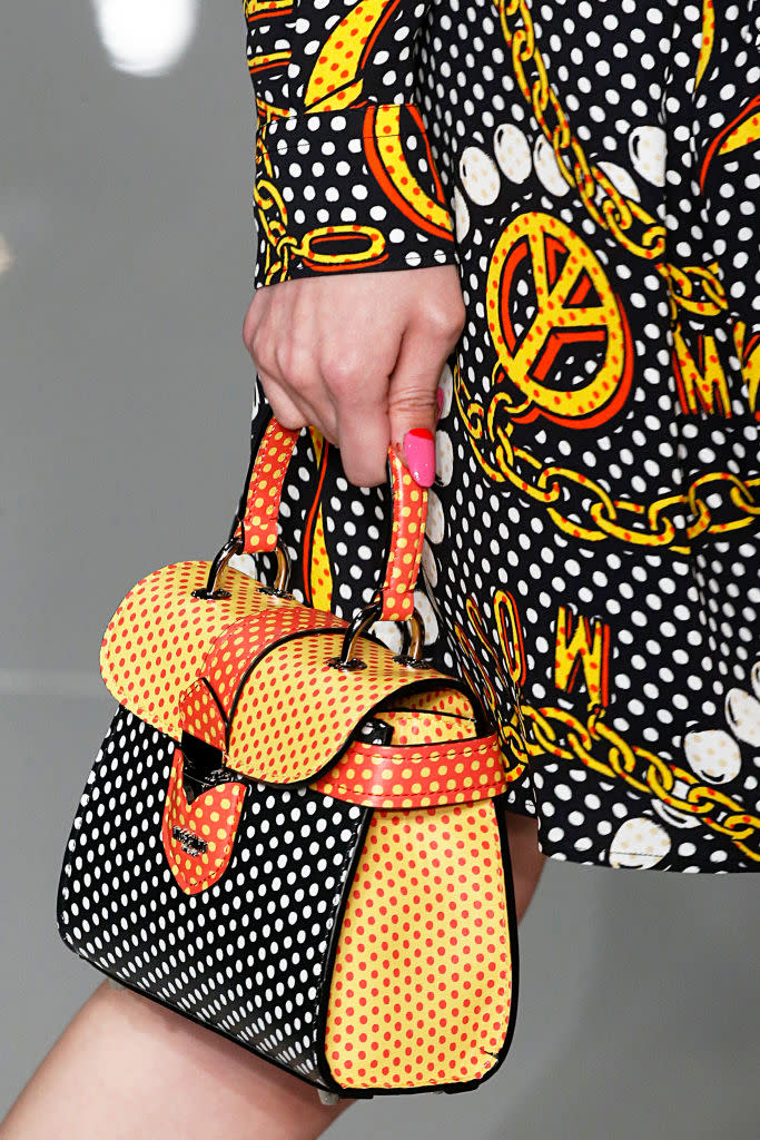 <p>A black, yellow, and orange polka dot bag from the Moschino FW18 show. (Photo: Getty Images) </p>