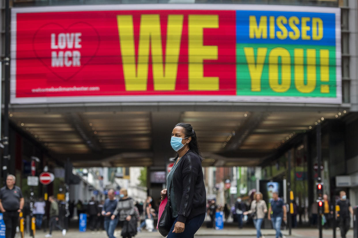 MANCHESTER, ENGLAND - JULY 24: A sign welcoming shoppers back to the town centre is displayed outside the Arndale centre on July 24, 2020 in Manchester, England. From today, consumers in the United Kingdom must wear face coverings in enclosed public spaces including shops, takeaways and public transport hubs.  (Photo by Anthony Devlin/Getty Images)