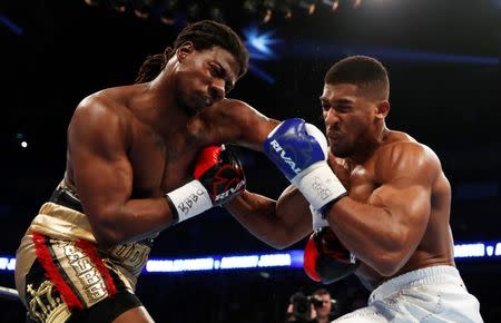 Charles Martin (left) was knocked down twice by Anthony Joshua who took his IBF Heavyweight Title belt