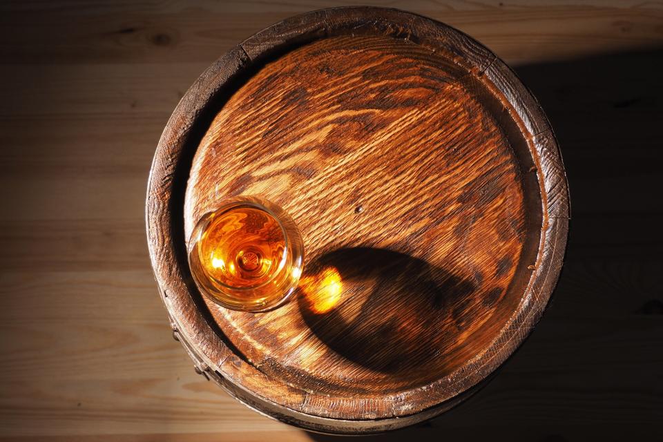 Glass os whisky on a cask