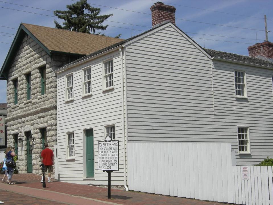 FILE - In this 2009 photo released by Mark Twain Boyhood Home & Museum, shown is Samuel Clemens' boyhood home, one of eight historic properties in the Mark Twain Boyhood Home & Museum complex in Hannibal, Mo. All the baseball teams are based in major U.S. cities and many of the stadiums are situated in bustling downtown areas with engrossing things to do and savory places to eat when you aren't attending a game. These attractions should help the cause of baseball fans trying to recruit a spouse or other traveling teammates who may not appreciate the sublime pleasures of the game. (AP Photo/Mark Twain Boyhood Home & Museum, Cindy Lovell)