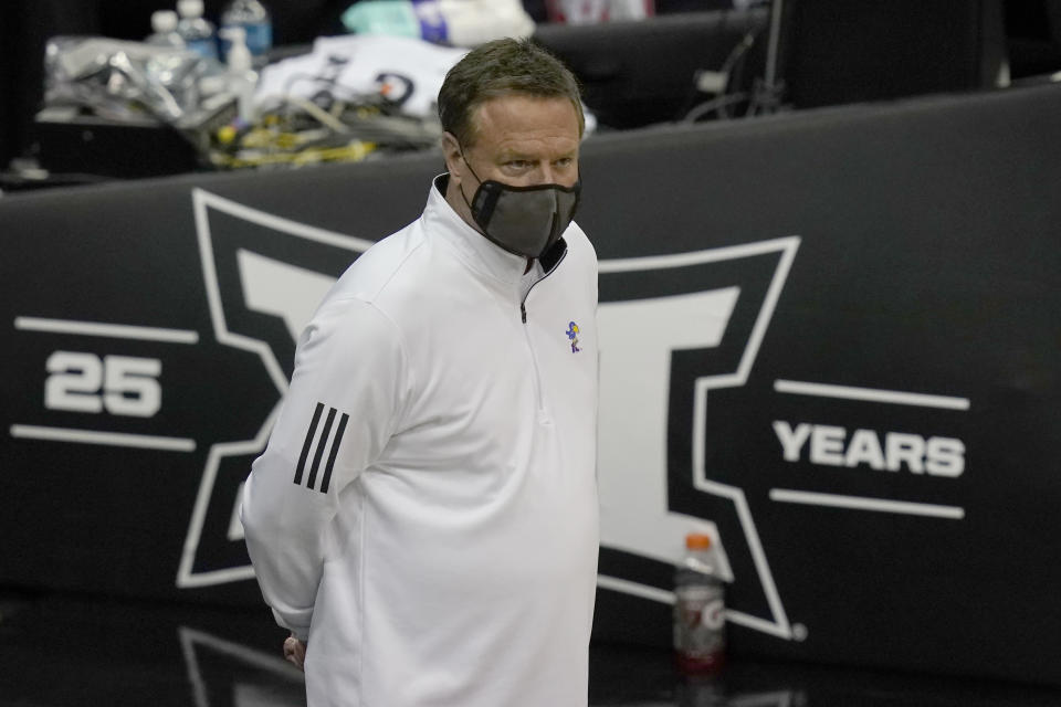 Kansas head coach Bill Self watches player introductions before an NCAA college basketball game against Oklahoma in the quarterfinal round of the Big 12 men's tournament in Kansas City, Mo., Thursday, March 11, 2021. (AP Photo/Orlin Wagner)