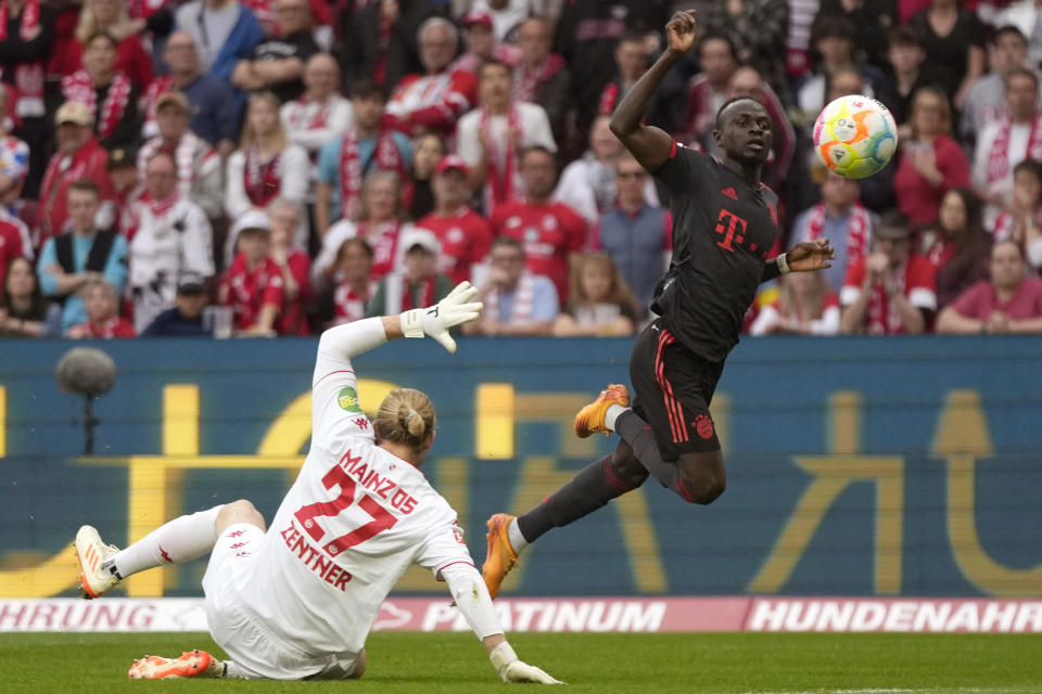 FILE - Bayern's Sadio Mane, right, scores a goal that was disallowed for offside during the German Bundesliga soccer match between 1. FSV Mainz 05 and FC Bayern Munich at the Mewa Arena in Mainz, Germany, Saturday, April 22, 2023. Bayern Munich’s president has confirmed that the club is aware of “initial talks” around a reported move for forward Sadio Mané from the German champion to Saudi Arabian club Al-Nassr. Bayern president Herbert Hainer says the club has been informed about the situation. (AP Photo/Matthias Schrader, File)