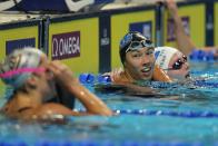 Torri Huske smiles after winning her heat in the Women's 100 Butterfly during wave 2 of the U.S. Olympic Swim Trials on Sunday, June 13, 2021, in Omaha, Neb. (AP Photo/Jeff Roberson)