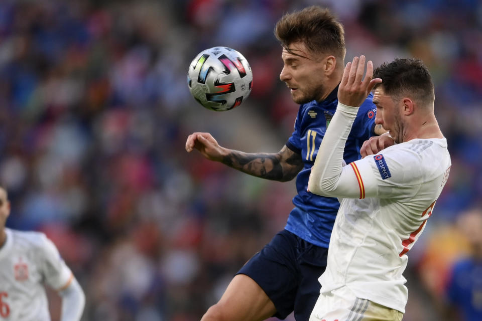 Italy's Ciro Immobile, left, and Spain's Aymeric Laporte vie for the ball during the Euro 2020 soccer semifinal match between Italy and Spain at Wembley stadium in London, Tuesday, July 6, 2021. (Laurence Griffiths, Pool via AP)
