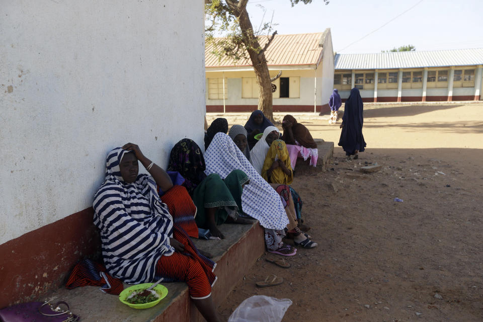 Parents of the missing Government Science secondary school students wait for news on their children in Kankara , Nigeria, Tuesday, Dec. 15, 2020. Rebels from the Boko Haram extremist group claimed responsibility Tuesday for abducting hundreds of boys from a school in Nigeria's northern Katsina State last week in one of the largest such attacks in years, raising fears of a growing wave of violence in the region. (AP Photo/Sunday Alamba)