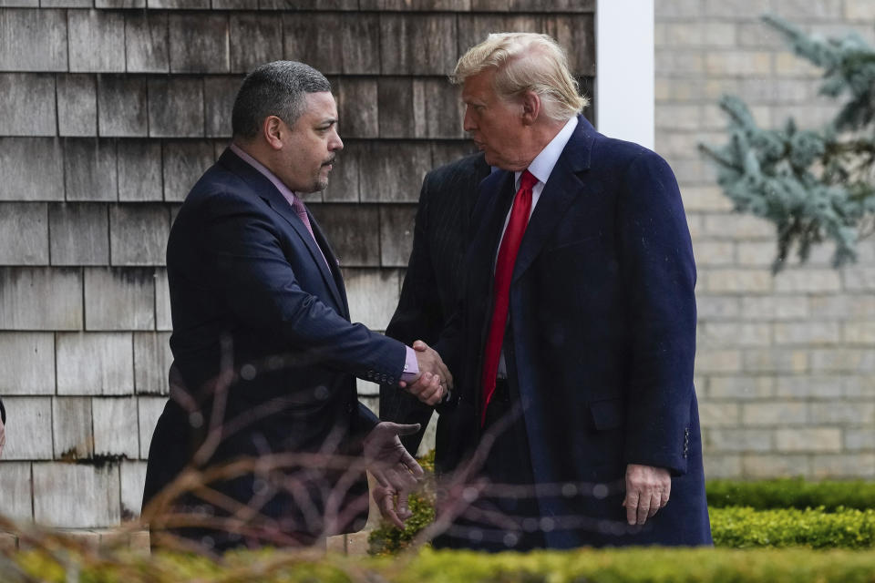 New York City Police Commissioner Edward A. Caban, left, shakes hands with Former President Donald Trump as he arrives for the wake of New York City police officer Jonathan Diller, Thursday, March 28, 2024, in Massapequa Park, N.Y. Diller was shot and killed Monday during a traffic stop, the city's mayor said. It marked the first slaying of an NYPD officer in two years. (AP Photo/Frank Franklin II)