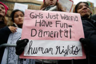 <p>A woman holds a sign that reads, “Girls just wanna have fundamental human rights,” during a rally at the Women’s March on Washington, Jan. 21, 2017. (Jessica Rinaldi/The Boston Globe via Getty Images) </p>