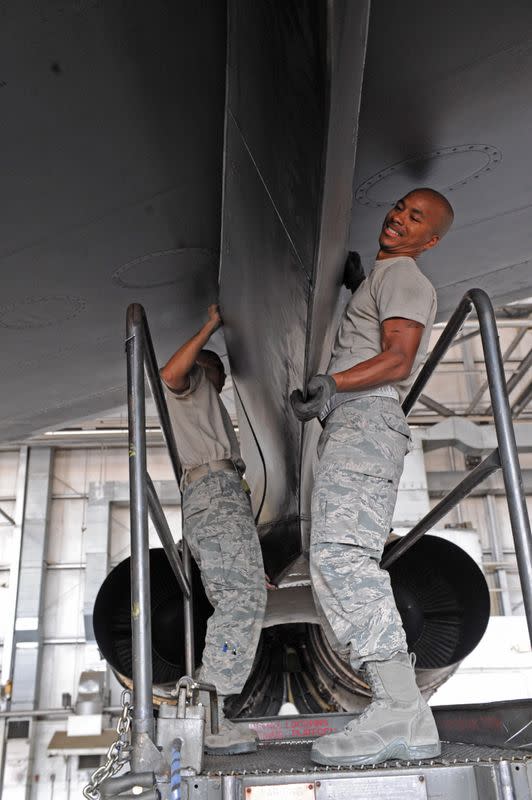 Airman 1st Class Deven Sherk works in a hangar