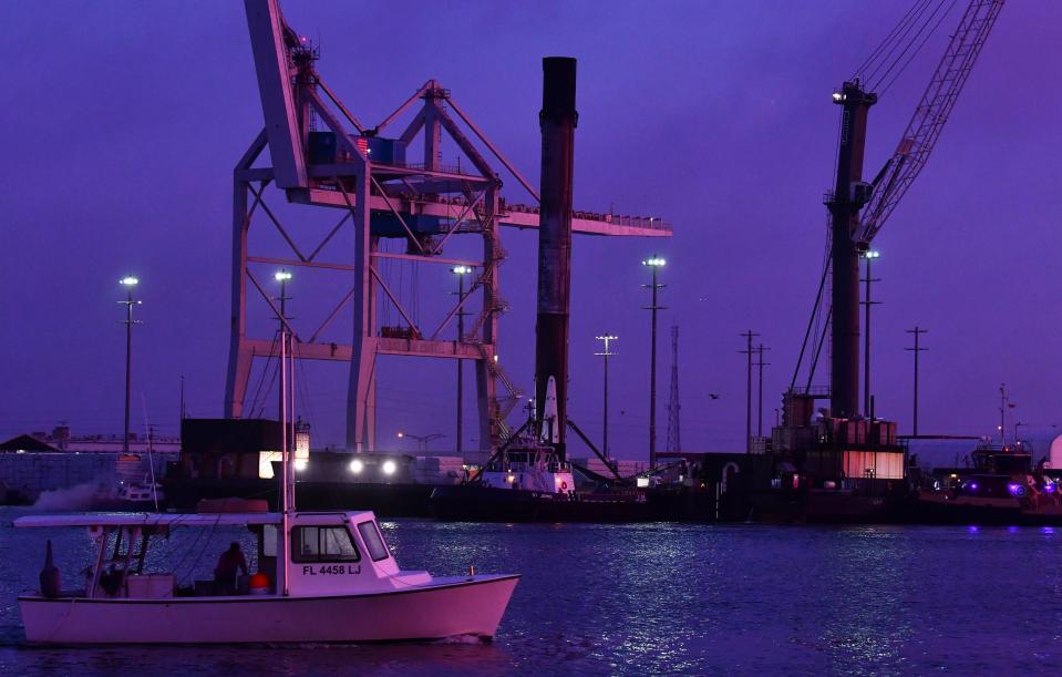 A SpaceX Falcon 9 booster arrives at Port Canaveral before dawn in December on the drone ship Just Read the Instructions.