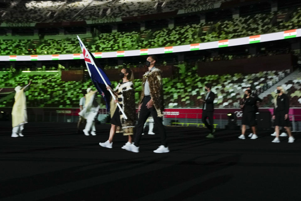 Sarah Hirini and David Nyika, of New Zealand, carry their country's flag during the opening ceremony in the Olympic Stadium at the 2020 Summer Olympics, Friday, July 23, 2021, in Tokyo, Japan. (AP Photo/Natacha Pisarenko)