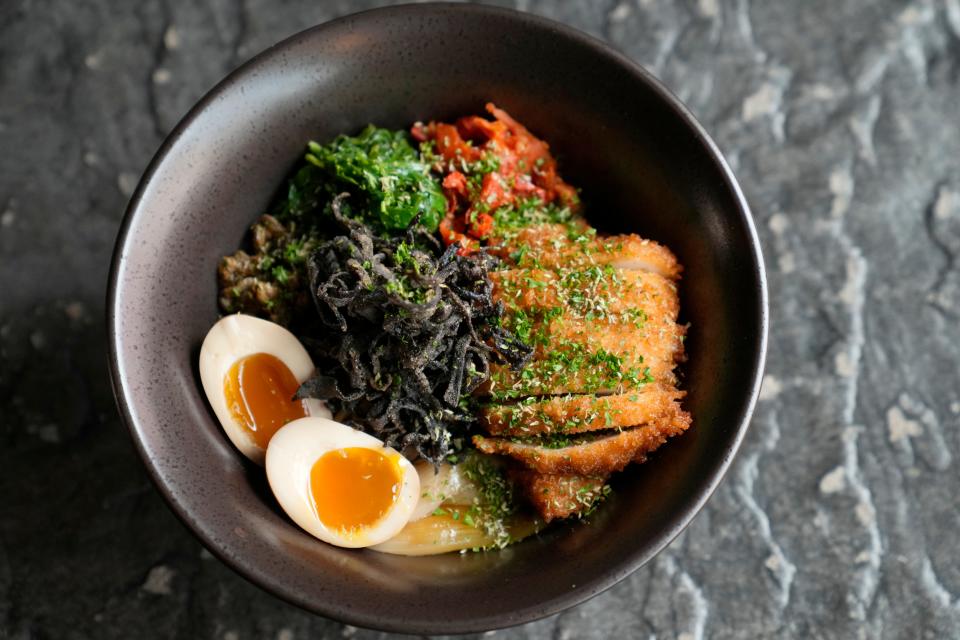 The fried chicken is served on the side of the chicken katsu ramen, preserving its crispiness.
