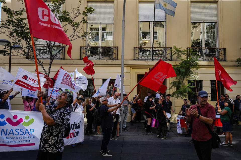 Members of Chile's Unitary Central of Workers demonstrate in support of the national strike in Argentina against economic and labor reforms proposed by Argentina's President Javier Milei, outside the Argentine embassy in Santiago, Chile, Wednesday, Jan. 24, 2024. (AP Photo/Esteban Felix)