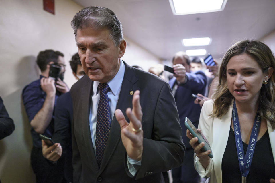 Sen. Joe Manchin, a crucial 50th vote for Democrats on President Joe Biden's proposals, walks with reporters as senators go to the chamber for votes ahead of the approaching Memorial Day recess, at the Capitol in Washington, Thursday, May 27, 2021.  / Credit: J. Scott Applewhite / AP