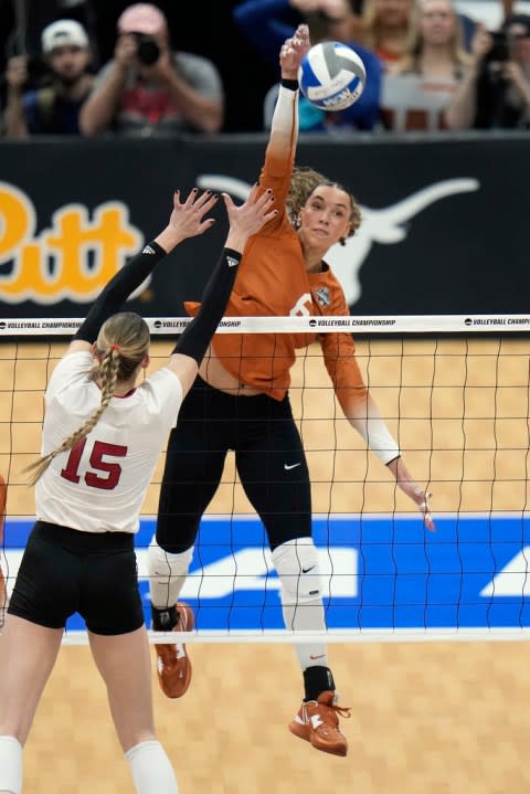 Texas’s Madisen Skinner (6) spikes the ball past Nebraska’s Andi Jackson (15) during the championship match in the NCAA Division I women’s college volleyball tournament Sunday, Dec. 17, 2023, in Tampa, Fla. (AP Photo/Chris O’Meara)