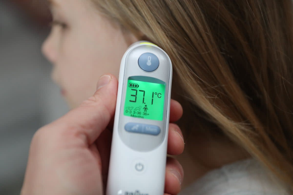 A child’s temperature of 37.1 degrees is taken using an ear thermometer. A high temperature (38C and above) can be a sign of Strep A infection (PA) (PA Archive)