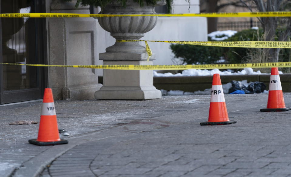 Police cones and tape are seen outside of a condominium building the day after a shooting in Vaughan, Ontario, on Monday Dec, 19, 2022. (Arlyn McAdorey/The Canadian Press via AP)