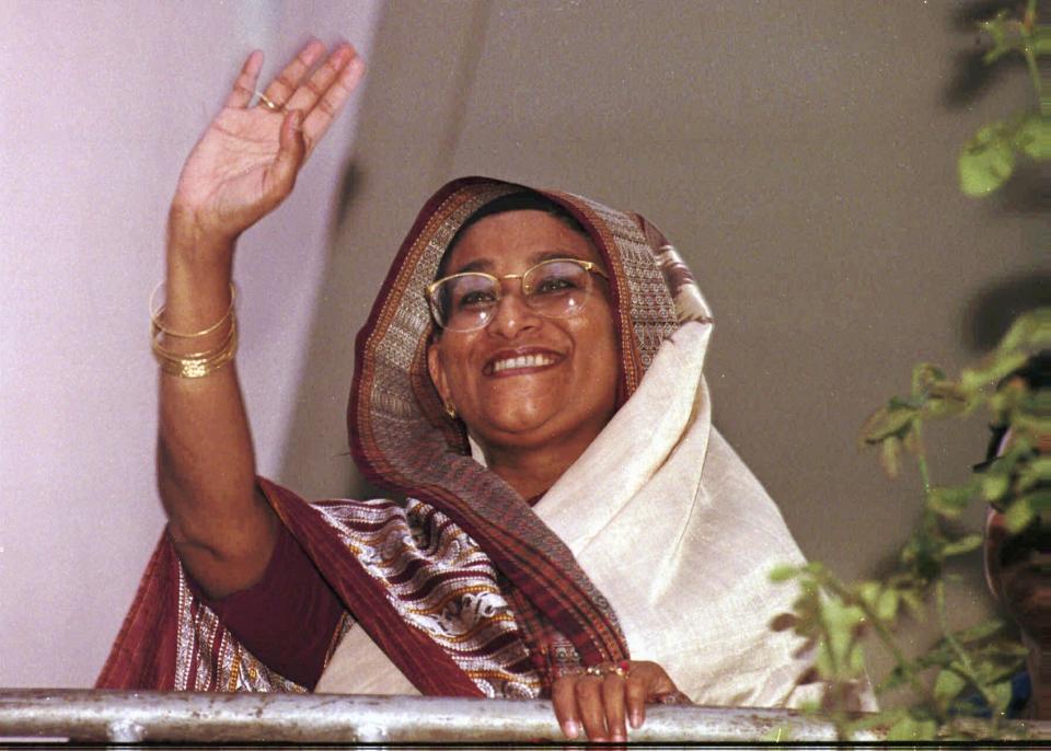 FILE- Sheikh Hasina, leader of the Awami League and the then leading contender to be the next prime minister of Bangladesh, waves to supporters from her home in Dhaka, June 17, 1996. The elections in Bangladesh are all about one person: Prime Minister Sheikh Hasina. Analysts predict that since the main opposition party is staying out of the Jan. 7 vote, the 76-year-old leader is practically guaranteed her fifth term in office. (AP Photo/Pavel Rahman, File)