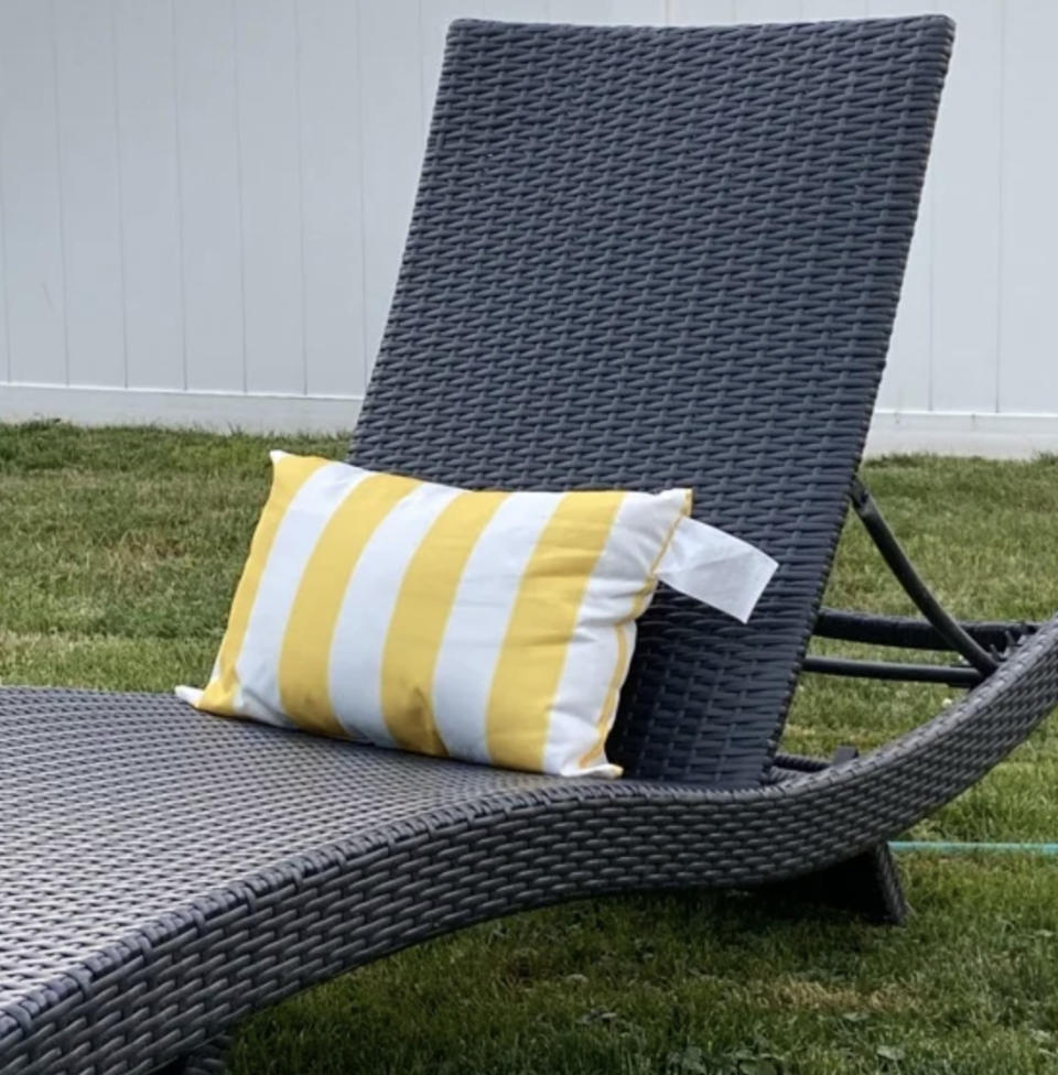 Reviewer's photo of outdoor wicker lounge chair with a yellow-striped cushion