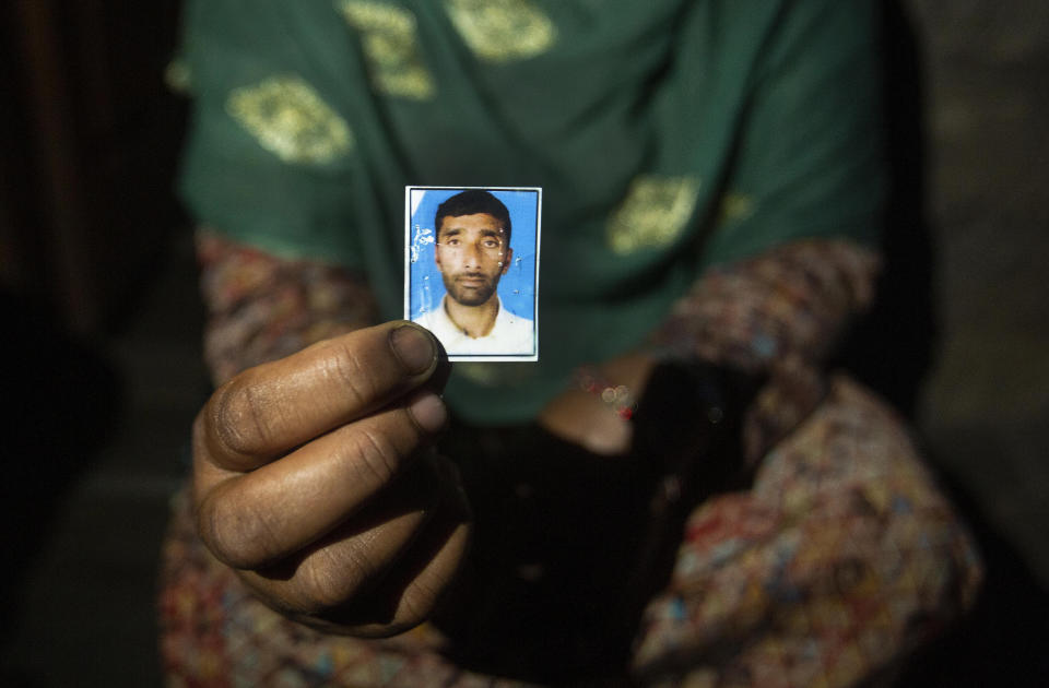 Zulikha, shows a picture of her husband Showket Ahmad who was killed by a bear last year at Dardkhor village in Srinagar, Indian controlled Kashmir, Monday, Aug. 24, 2020. Amid the long-raging deadly strife in Indian-controlled Kashmir, another conflict is silently taking its toll on the Himalayan region’s residents: the conflict between man and wild animals. According to official data, at least 67 people have been killed and 940 others injured in the past five years in attacks by wild animals in the famed Kashmir Valley, a vast collection of alpine forests, connected wetlands and waterways known as much for its idyllic vistas as for its decades-long armed conflict between Indian troops and rebels. (AP Photo/Mukhtar Khan)