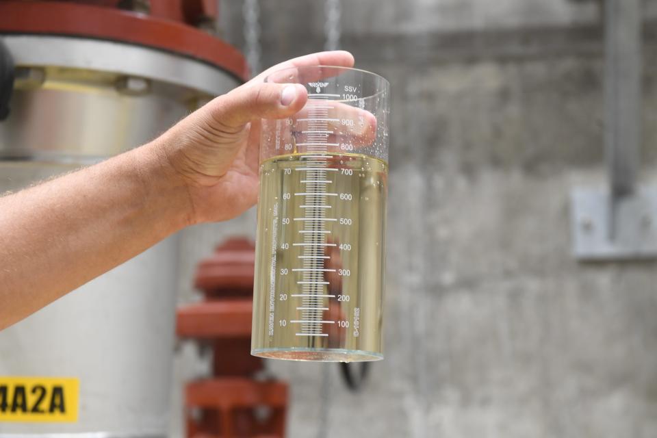 Smithfield Foods Director of Environmental Affairs Jason Lindquist lifts a beaker of water that's been filtered through the company's new wastewater treatment facility at Smithfield Foods in Sioux Falls, South Dakota on Wednesday, August 16, 2023. Lindquist said Sioux Falls plant's new system should reduce their outgoing nitrate emissions by two-thirds.