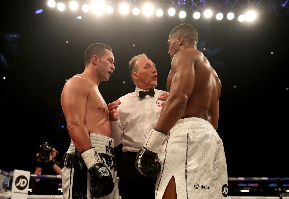 <p>Quiet word: Referee Giuseppe Quartarone speaks with Joseph Parker (left) after the British fighter threw an uppercut after the bell in round 7 </p>