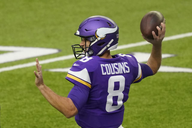 Minnesota Vikings quarterback Kirk Cousins takes the field before