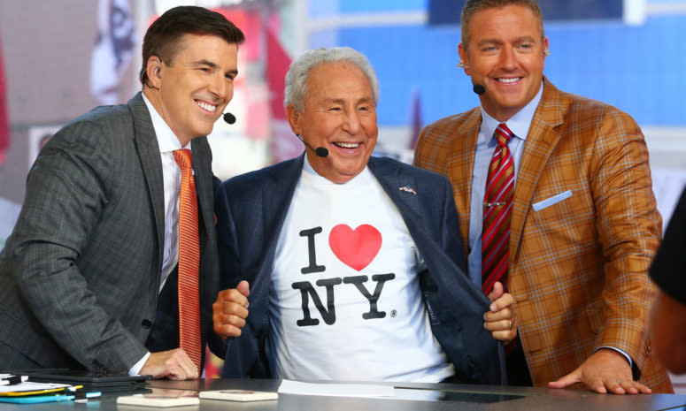 Lee Corso wearing an I Love New York T-Shirt while posing for a photo with Kirk Herbstreit and Chris Fowler on a College GameDay episode.