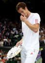 Andy Murray of Great Britain reacts while holding his runners up trophy after being defeated in his Gentlemen's Singles final match against Roger Federer at Wimbledon.