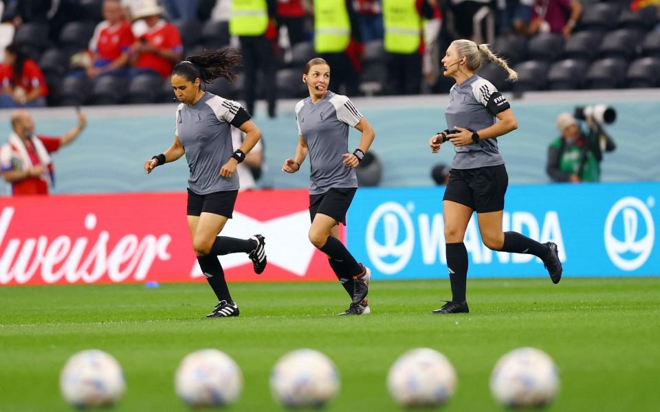 Referee Stephanie Frappart warm up alongside assistant referees Neuza Back and Karen Diaz Medina before the match - Matthew Childs/Reuters