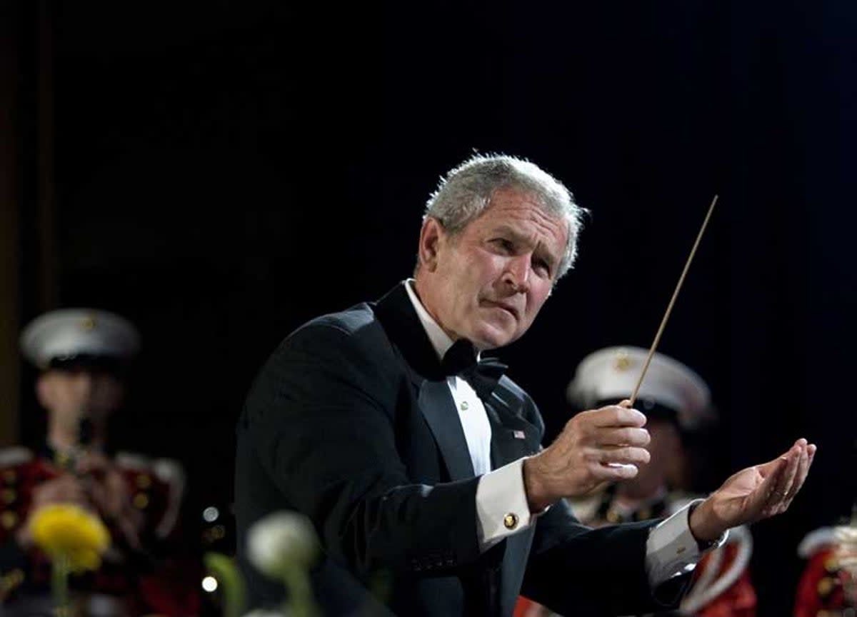 President George Bush conducts the US Marine Corps Band at the White House Correspondents Association Dinner in 2008. (AP)