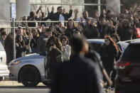 (Trent Nelson | The Salt Lake Tribune) People evacuate with their hands aloft after a shooting at the Fashion Place Mall in Murray on Sunday Jan. 13, 2019.(Trent Nelson/The Salt Lake Tribune via AP)