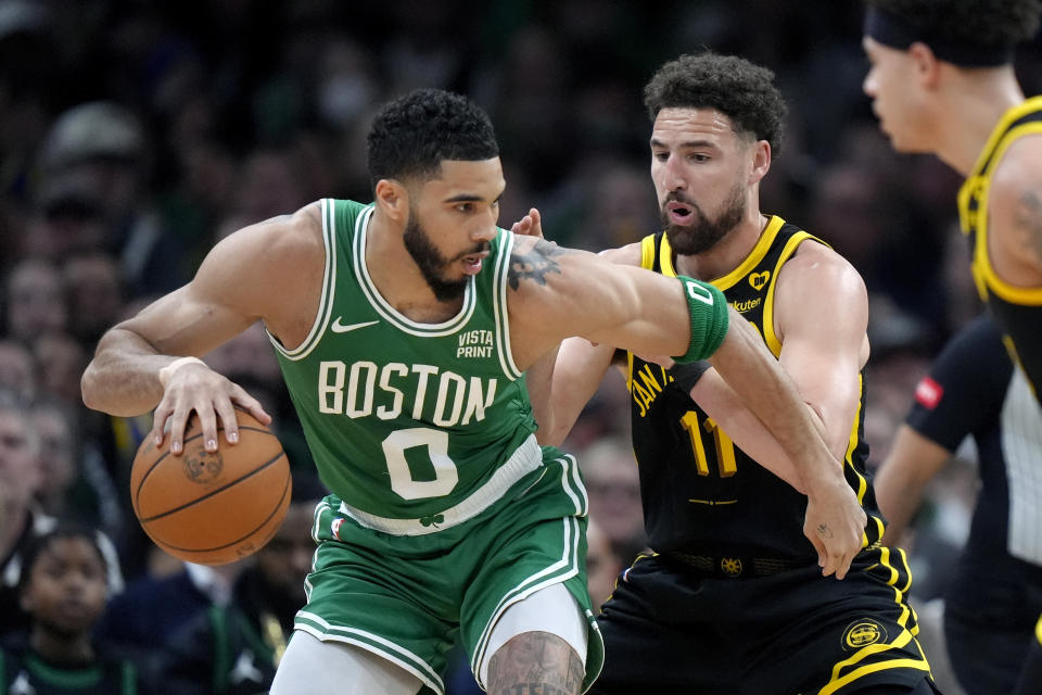 Boston Celtics forward Jayson Tatum (0) drives to the basket as Golden State Warriors guard Klay Thompson (11) defends in the first half of an NBA basketball game, Sunday, March 3, 2024, in Boston. (AP Photo/Steven Senne)