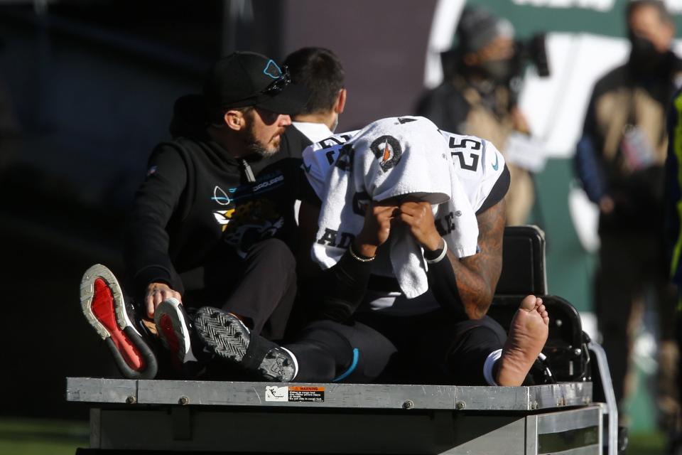 Jaguars running back James Robinson (25) is carted off the field during the first half against the New York Jets on Dec. 26, 2021, in East Rutherford, N.J.