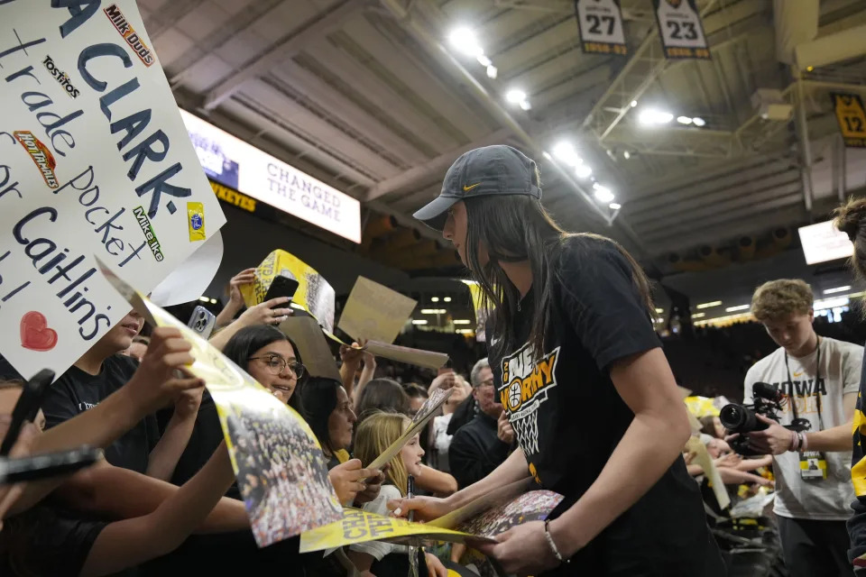 Iowa guard Caitlin Clark signs autographs during an Iowa women's basketball team celebration Wednesday, April 10, 2024, in Iowa City, Iowa. Iowa lost to South Carolina in championship game of college basketball's women's NCAA Tournament on Sunday. (AP Photo/Charlie Neibergall)