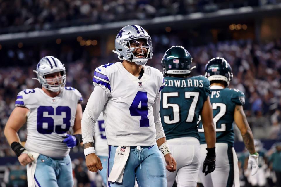 Dak Prescott celebrates after throwing a touchdown pass to tight end Dalton Schultz.