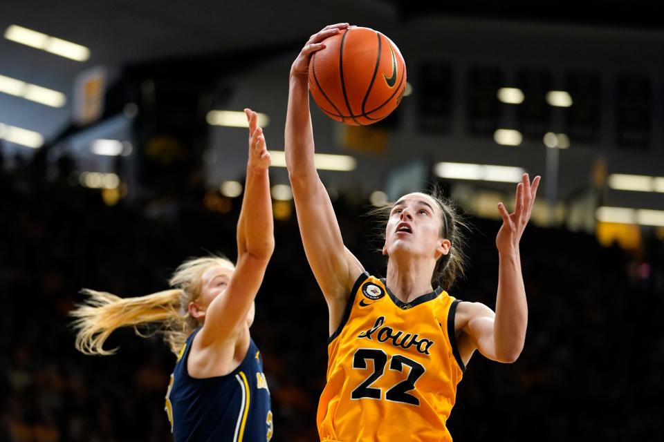 Iowa guard Caitlin Clark (22) grabs a rebound ahead of Michigan guard Maddie Nolan, left, during the first half on Sunday, Feb. 27, 2022, at Carver-Hawkeye Arena in Iowa City, Iowa.