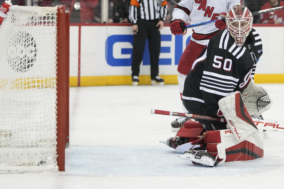 New Jersey Devils goaltender Nico Daws watches as the puck hits the net after Carolina Hurricanes center Martin Necas scored during the first period of an NHL hockey game, Saturday, March 9, 2024, in Newark, N.J. (AP Photo/Mary Altaffer)