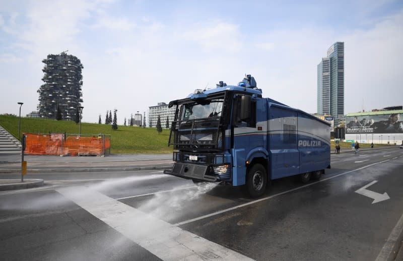 A vehicle of the Italian police sanitizes a street amid concerns about the spread of coronavirus disease (COVID-19) in Milan