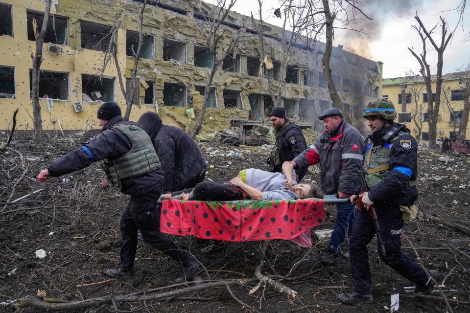 FILE- Iryna Kalinina, 32, an injured pregnant woman, is carried from a maternity hospital that was damaged during a Russian airstrike in Mariupol, Ukraine, on 9 March 2022. Associated Press photographer Evgeniy Maloletka won the World Press Photo of the Year award on Thursday, April 20, 2023, for this harrowing image of emergency workers carrying a pregnant woman through the shattered grounds of a maternity hospital in the Ukrainian city of Mariupol in the chaotic aftermath of a Russian attack.
