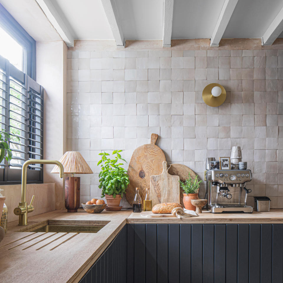 White tiled kitchen with painted cabinets and wooden worktops