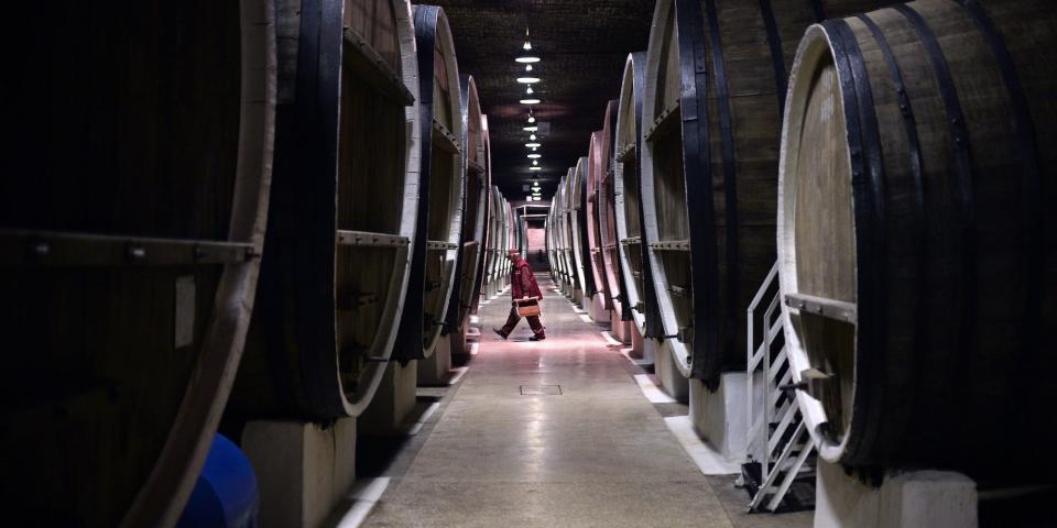 A view through rows of large barrels at Inkerman Winery, southeast of Sevastopol, Crimea, in March 2014. A worker walks in the distance.