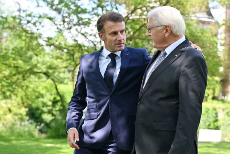 French President Emmanuel Macron (L),  of France, and German President Frank-Walter Steinmeier walk through the park of Wilkinghege Castle. Macron and his wife are on a three-day state visit to Germany at the invitation of German President Steinmeier. David Inderlied/dpa