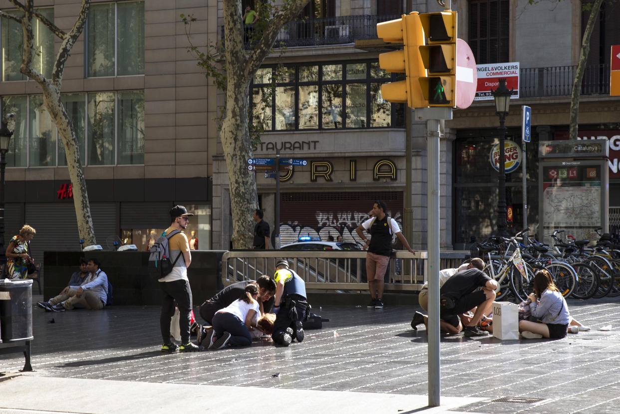 Injured people are tended to near the scene of a terrorist attack in the Las Ramblas area Thursday in Barcelona. (Photo: Nicolas Carvalho Ochoa via Getty Images)