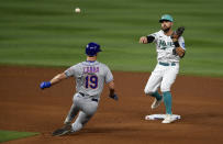 Miami Marlins third baseman Jon Berti (5) turns a double play in front of New York Mets' Mark Canha (19) during the fifth inning of a baseball game, Friday, March 31, 2023, in Miami. (AP Photo/Michael Laughlin)