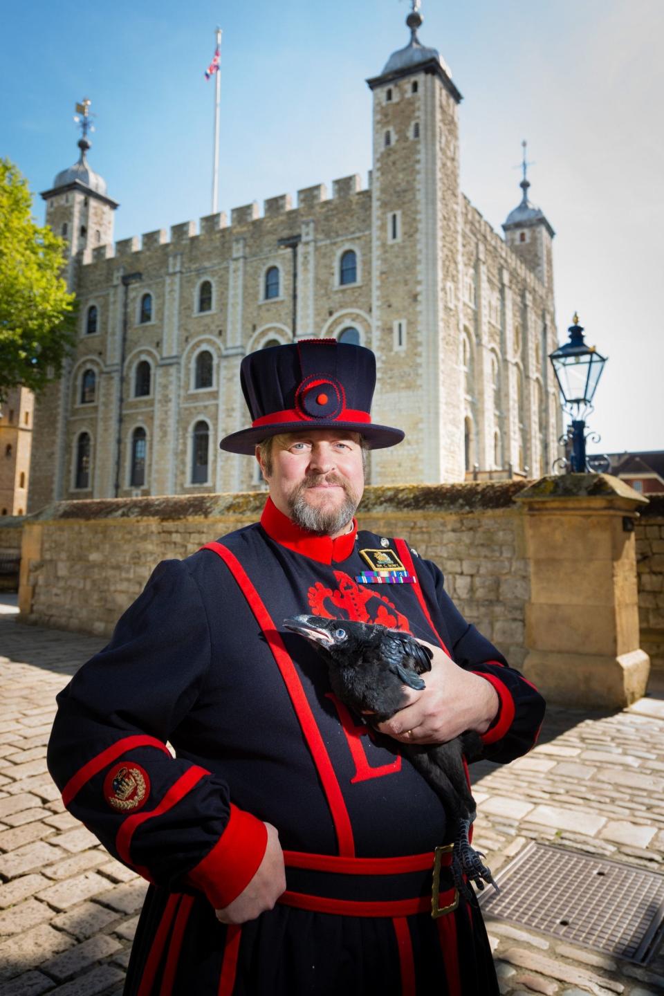 Ravenmaster Chris Skaife holding one of the first ravens to be born at the Tower in 30 years.PA