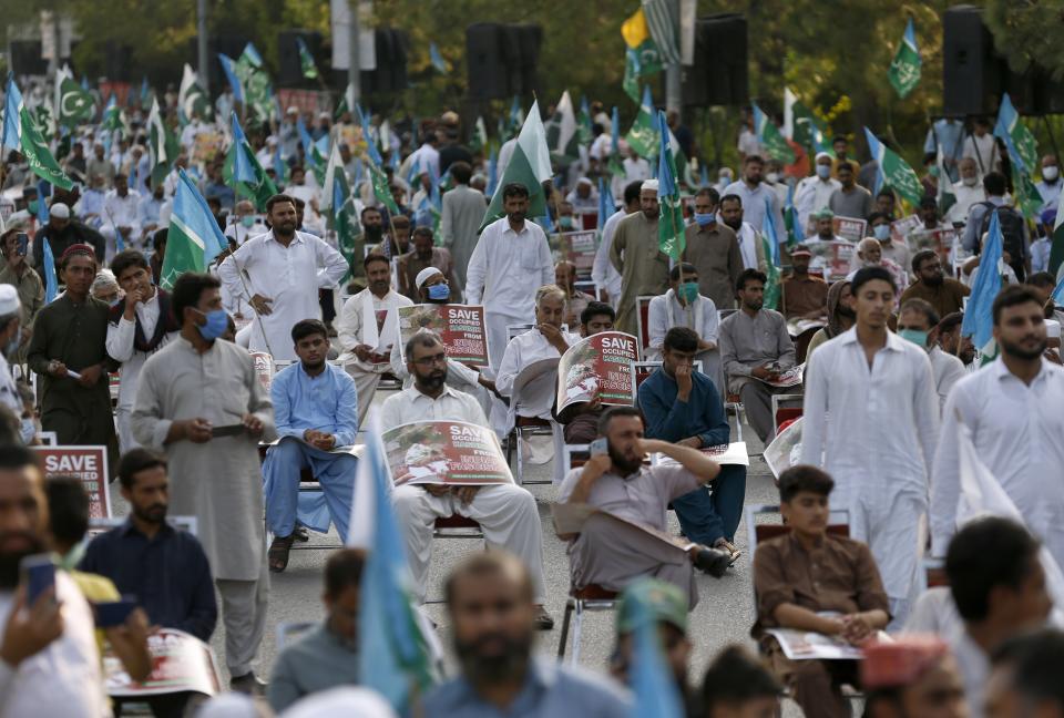 Supporters of a religious group Jamaat-e-Islami take part in a rally to show solidarity with the Kashmiri people on the eve of first anniversary of India's decision to revoke the disputed region's semi-autonomy, in Islamabad, Pakistan, Wednesday, Aug. 5, 2020. Last year on Aug. 5, India's Hindu-nationalist-led government of Prime Minister Narendra Modi stripped Jammu and Kashmir's statehood, scrapped its separate constitution and removed inherited protections on land and jobs. (AP Photo/Anjum Naveed)