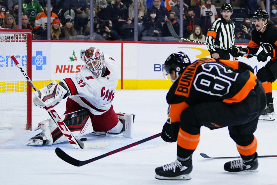 Carolina Hurricanes' Antti Raanta, left, blocks a shot by Philadelphia Flyers' Connor Bunnaman during the second period of an NHL hockey game, Friday, Nov. 26, 2021, in Philadelphia. (AP Photo/Matt Slocum)