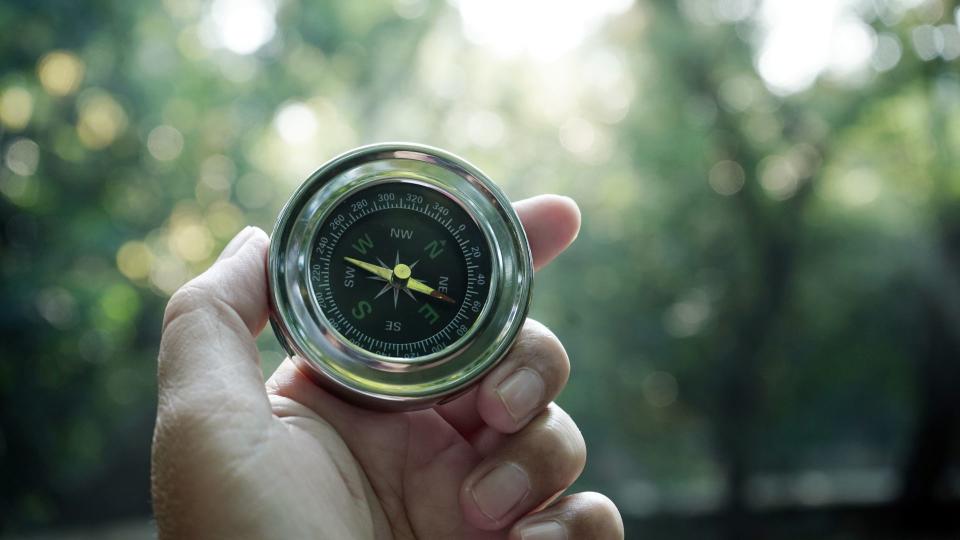 Compass being used on a hike