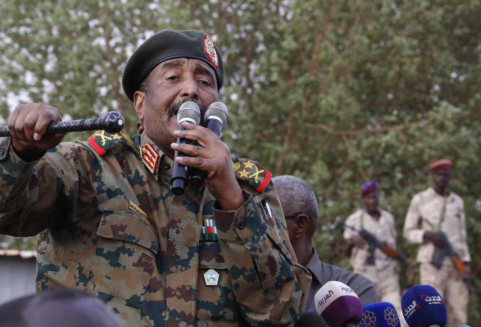 FILE - In this June 29, 2019, file photo, Sudanese Gen. Abdel-Fattah Burhan, head of the military council, speaks during a military-backed rally, in Omdurman district, west of Khartoum, Sudan. An African Union envoy says Sudan's ruling military council and the country's pro-democracy movement have reached a power-sharing agreement, including a timetable for a transition to civilian rule. Mohammed el-Hassan Labat said early Friday, July 5, that both sides agreed to form a joint sovereign council that will rule the country for "three years or a little more." The sides agreed to five seats for the military and five for civilians with an additional seat going to a civilian with military background.(AP Photo/Hussein Malla, File)